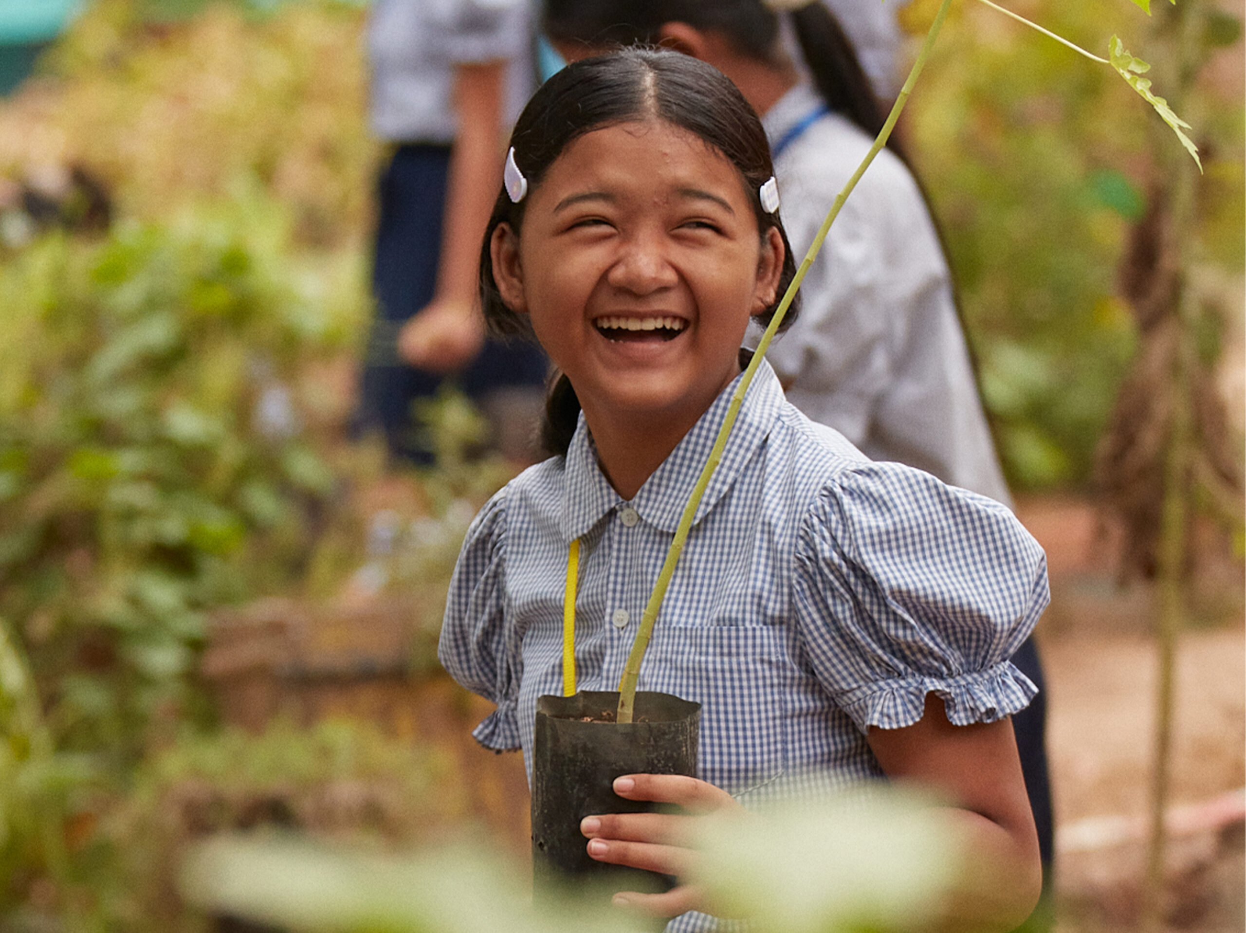 laughing-cambodian-girl-planting